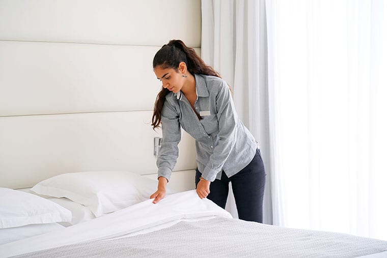 Maid cleaning a cruise stateroom